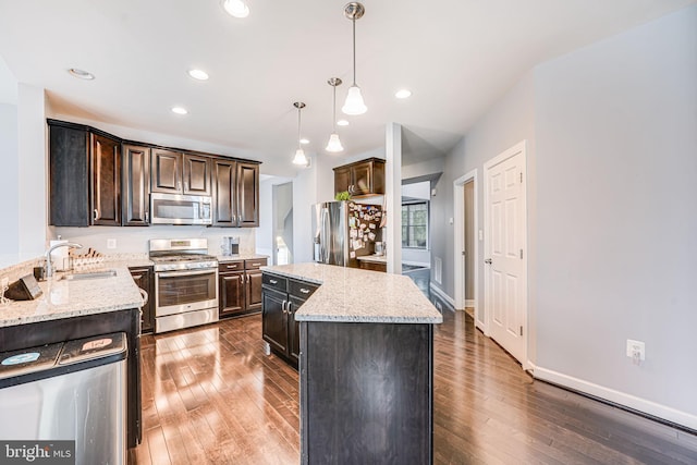 3104 Reach Eagle Ct, Woodbridge, VA 22191 - kitchen with stainless steel appliances, a sink, wood-type flooring, dark brown cabinets, and recessed lighting