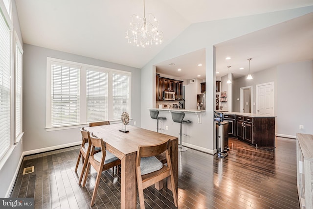 3104 Reach Eagle Ct, Woodbridge, VA 22191 - dining room with dark wood-style floors, lofted ceiling, baseboards, and a chandelier