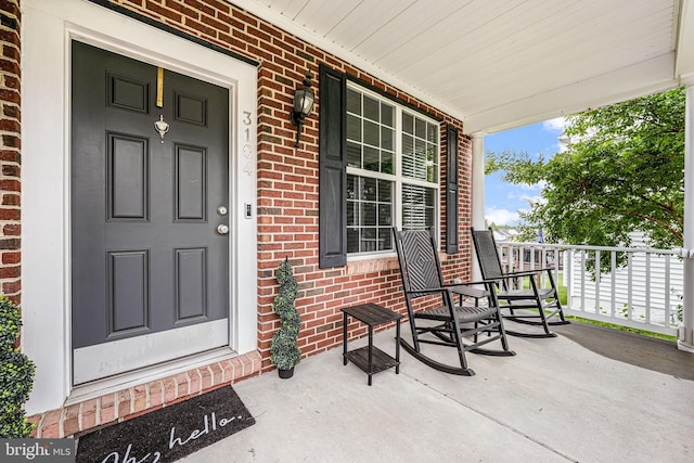 3104 Reach Eagle Ct, Woodbridge, VA 22191 - doorway to property featuring covered porch and brick siding