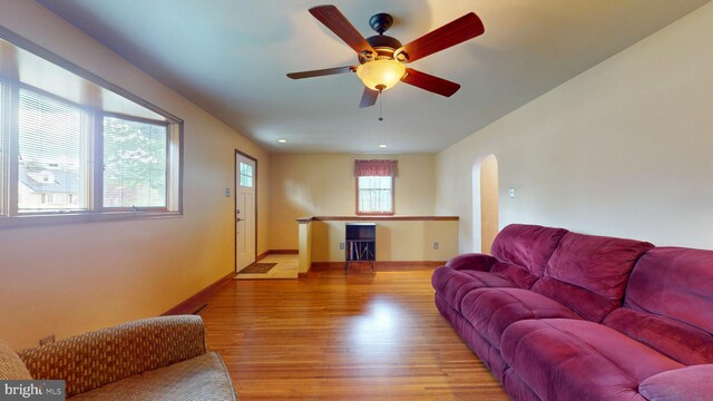 38 Ward Ave, Audubon, NJ 08106 - living area featuring arched walkways, light wood-style flooring, baseboards, and ceiling fan