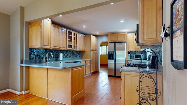 38 Ward Ave, Audubon, NJ 08106 - kitchen with stainless steel fridge with ice dispenser, a sink, tasteful backsplash, glass insert cabinets, and recessed lighting