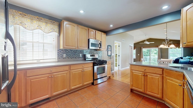 38 Ward Ave, Audubon, NJ 08106 - kitchen featuring stainless steel appliances, lofted ceiling, light tile patterned floors, decorative backsplash, and a sink