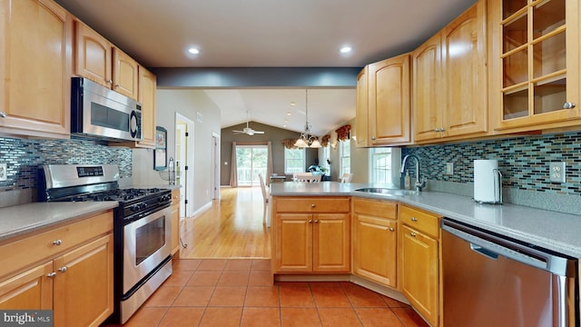 38 Ward Ave, Audubon, NJ 08106 - kitchen with appliances with stainless steel finishes, a sink, vaulted ceiling, light tile patterned floors, and glass insert cabinets