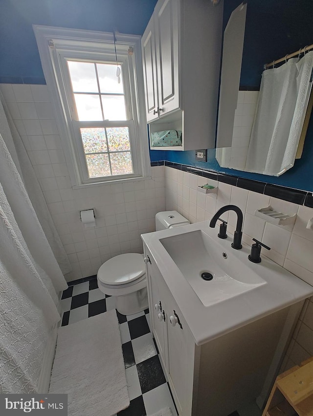 1413 Belle View Blvd Unit C1, Alexandria, VA 22307 - bathroom with tile walls, tile patterned floors, toilet, vanity, and a wainscoted wall