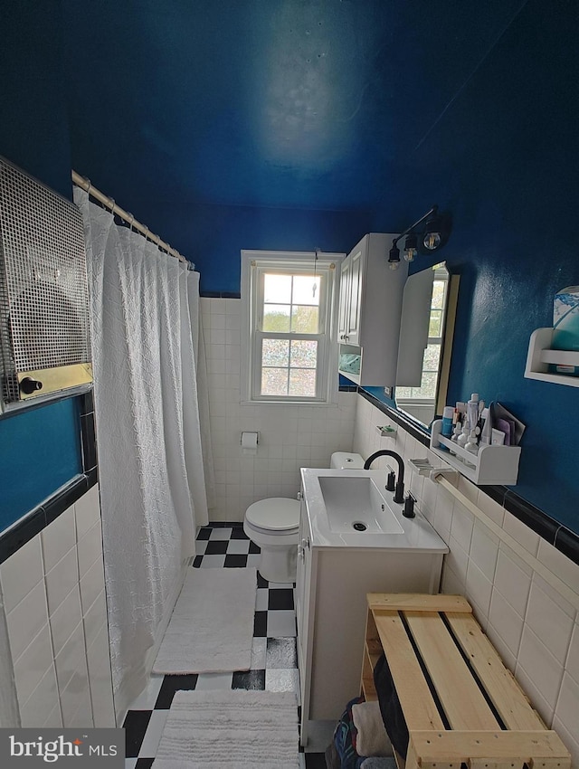 1413 Belle View Blvd Unit C1, Alexandria, VA 22307 - bathroom featuring tile walls, toilet, a shower with shower curtain, vanity, and wainscoting