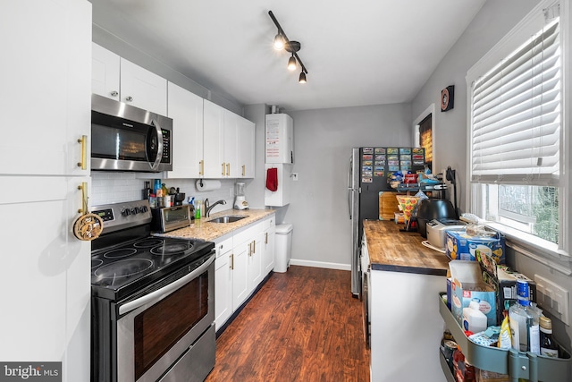 221 Walnut St, West Deptford, NJ 08096 - kitchen featuring appliances with stainless steel finishes, butcher block countertops, backsplash, dark wood-style floors, and a sink