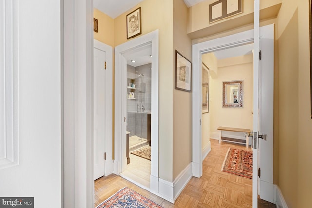 hall featuring baseboards
