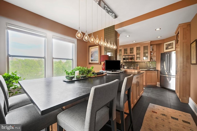 dining room with recessed lighting and baseboards