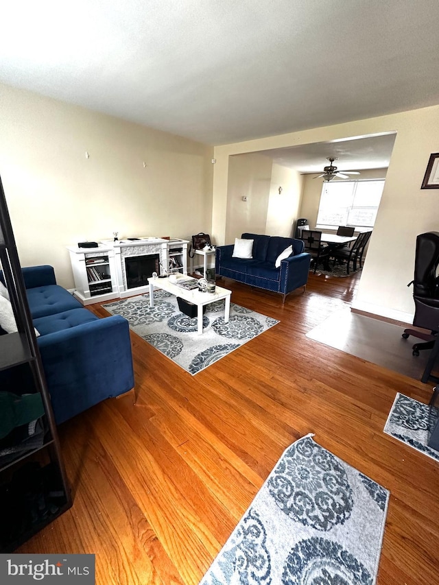 912 Evesham Ave, Baltimore, MD 21212 - living room with wood finished floors, a ceiling fan, and a fireplace