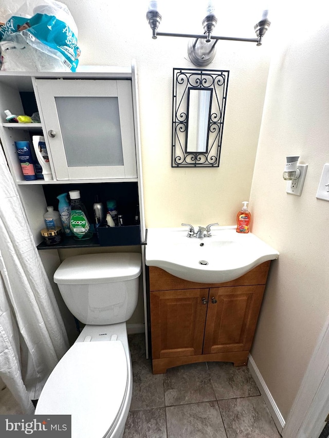 912 Evesham Ave, Baltimore, MD 21212 - bathroom with vanity, toilet, and tile patterned flooring