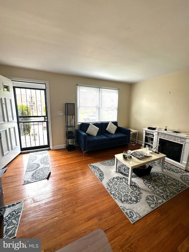 912 Evesham Ave, Baltimore, MD 21212 - living room with plenty of natural light, light wood-style floors, a fireplace, and baseboards