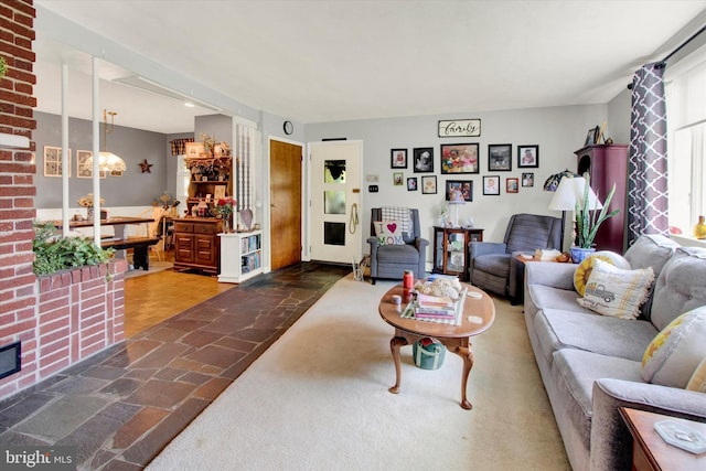 400 Hill Cir, Reading, PA 19607 - living room featuring stone finish flooring and a chandelier