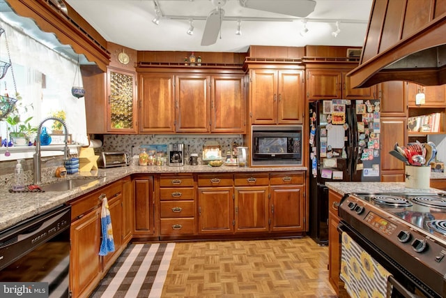 400 Hill Cir, Reading, PA 19607 - kitchen featuring black appliances, a sink, brown cabinets, track lighting, and light stone countertops