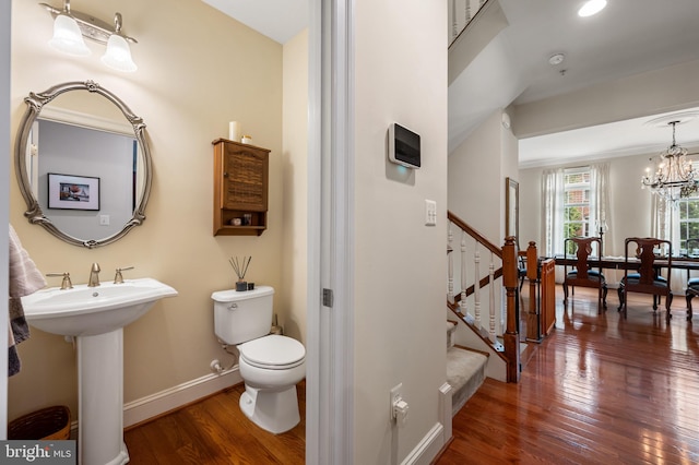 7311 Trappe St, Fulton, MD 20759 - half bathroom featuring hardwood / wood-style floors, toilet, baseboards, a chandelier, and a sink