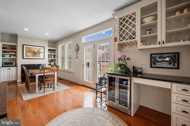 7311 Trappe St, Fulton, MD 20759 - dining room featuring beverage cooler, a bar, light wood-style floors, baseboards, and recessed lighting