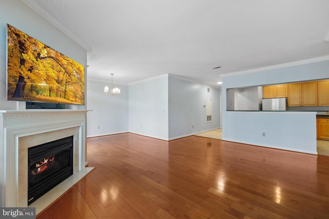 4950 Brenman Park Dr Unit 301, Alexandria, VA 22304 - unfurnished living room featuring crown molding, a fireplace with flush hearth, light wood-style floors, a chandelier, and baseboards