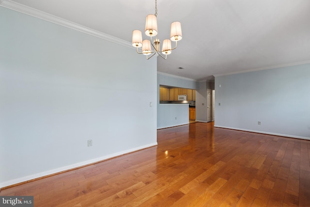 4950 Brenman Park Dr Unit 301, Alexandria, VA 22304 - unfurnished living room with ornamental molding, baseboards, hardwood / wood-style floors, and a chandelier