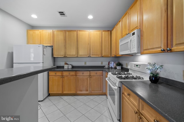 4950 Brenman Park Dr Unit 301, Alexandria, VA 22304 - kitchen with white appliances, dark countertops, light tile patterned flooring, recessed lighting, and brown cabinets