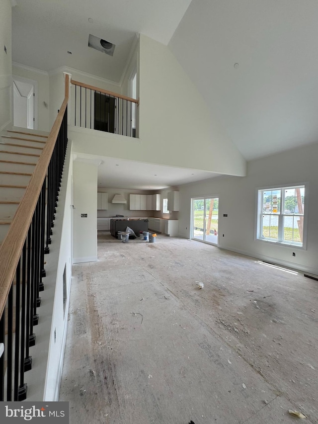 26171 Millman Dr, Hebron, MD 21830 - unfurnished living room featuring a towering ceiling and stairway