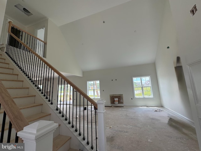 26171 Millman Dr, Hebron, MD 21830 - staircase featuring high vaulted ceiling, healthy amount of natural light, a fireplace, and baseboards
