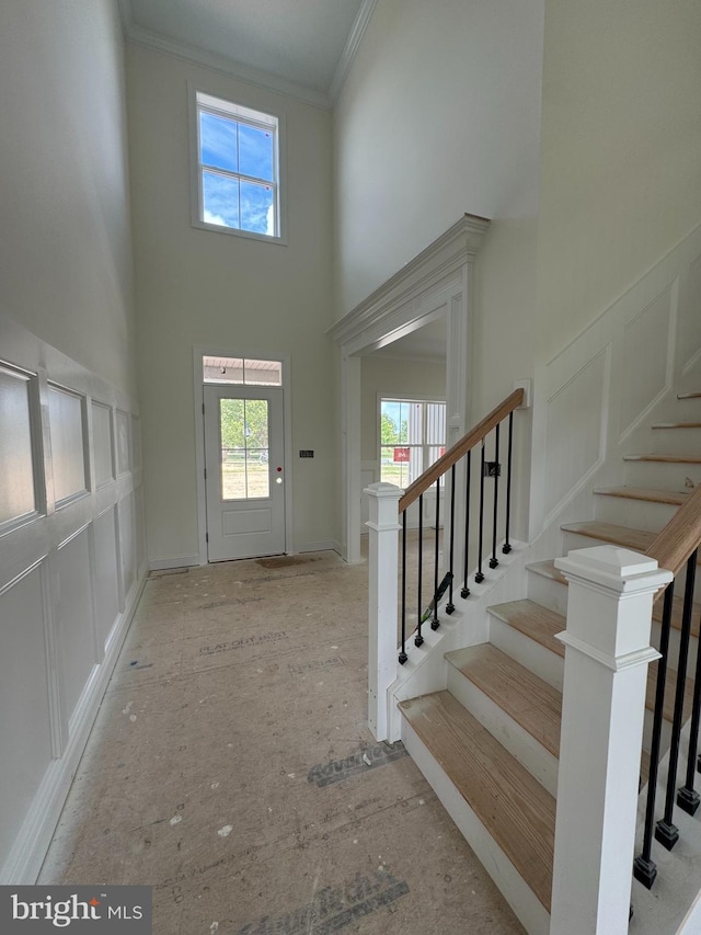 26171 Millman Dr, Hebron, MD 21830 - foyer entrance featuring a towering ceiling, plenty of natural light, ornamental molding, and stairs