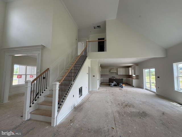 26171 Millman Dr, Hebron, MD 21830 - unfurnished living room featuring high vaulted ceiling and stairs