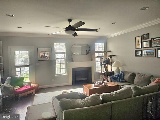 211 Clear Sky Way, Pasadena, MD 21122 - living area featuring a fireplace with flush hearth, a ceiling fan, ornamental molding, light wood-style floors, and recessed lighting