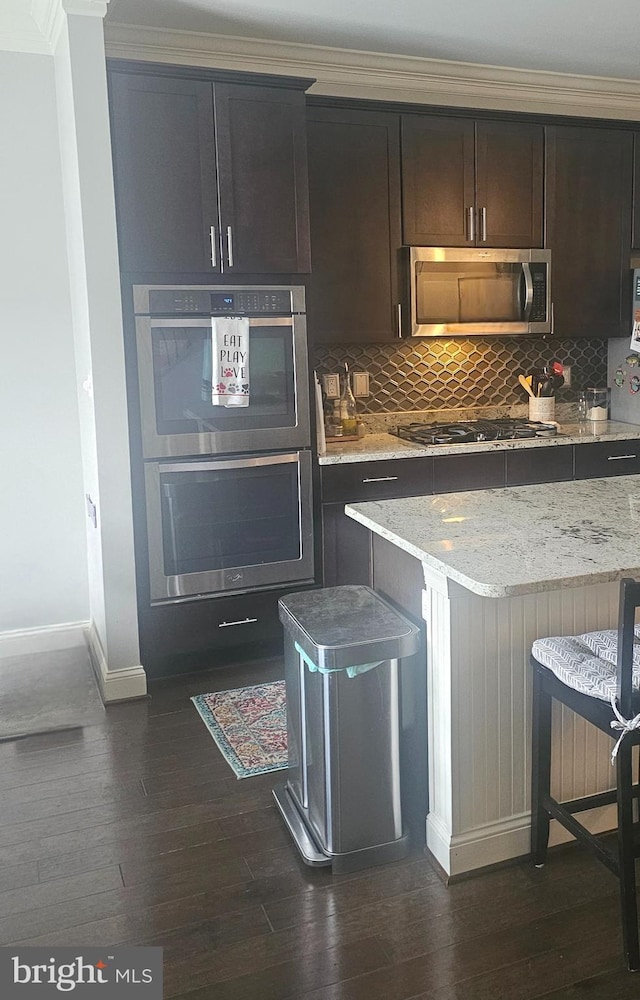 211 Clear Sky Way, Pasadena, MD 21122 - kitchen featuring stainless steel appliances, baseboards, dark wood-type flooring, backsplash, and ornamental molding