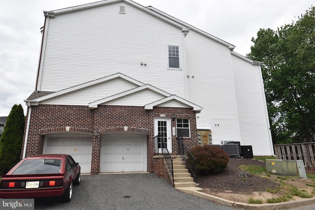 1304 Cranesbill Ct Unit 304, Belcamp, MD 21017 - view of front facade with driveway, brick siding, cooling unit, and fence