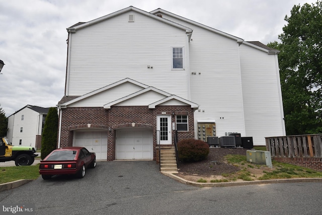 1304 Cranesbill Ct Unit 304, Belcamp, MD 21017 - view of front of property with asphalt driveway, brick siding, a garage, and central AC