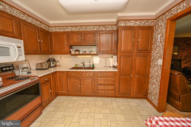 206-208 N 10th St, Oakland, MD 21550 - kitchen with electric range, white microwave, a sink, light countertops, and brown cabinets