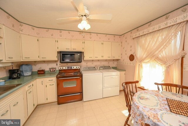 206-208 N 10th St, Oakland, MD 21550 - kitchen with black microwave, electric range oven, washer and dryer, wallpapered walls, and light flooring