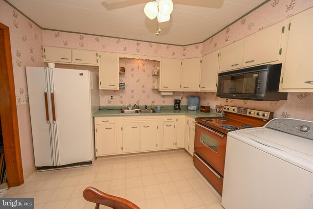 206-208 N 10th St, Oakland, MD 21550 - kitchen with freestanding refrigerator, washer / dryer, black microwave, wallpapered walls, and range with electric stovetop