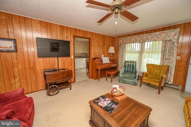 206-208 N 10th St, Oakland, MD 21550 - living room featuring washing machine and dryer, wooden walls, carpet floors, a baseboard radiator, and ceiling fan