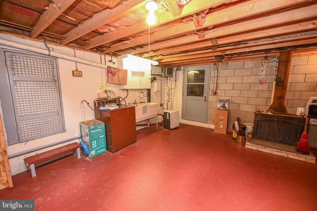 206-208 N 10th St, Oakland, MD 21550 - unfinished basement featuring a wood stove and concrete block wall