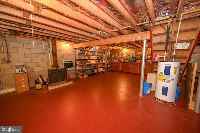 206-208 N 10th St, Oakland, MD 21550 - unfinished basement with electric water heater, a wood stove, concrete block wall, and heating unit