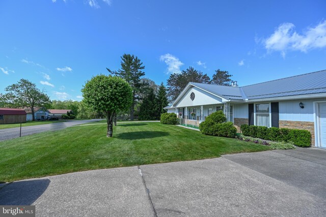 206-208 N 10th St, Oakland, MD 21550 - view of home's exterior featuring a lawn, metal roof, stone siding, a porch, and board and batten siding