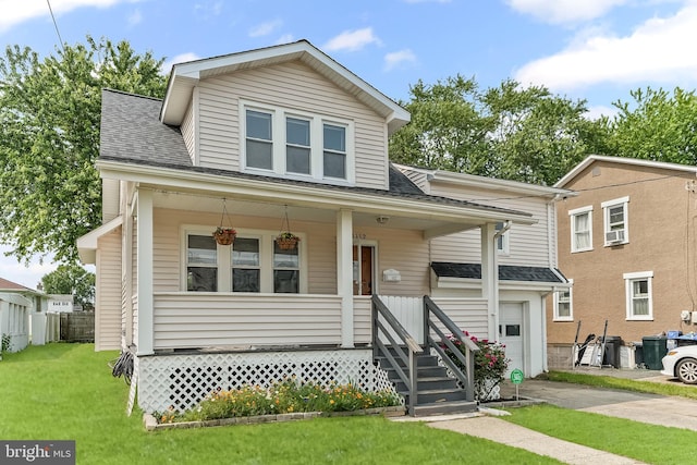 1112 Randall Ave, Upper Chichester, PA 19061 - bungalow with covered porch, a front yard, and roof with shingles