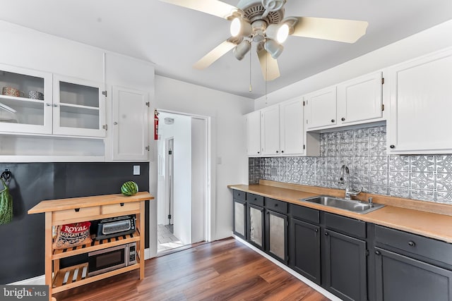 1112 Randall Ave, Upper Chichester, PA 19061 - kitchen with a sink, white cabinetry, ceiling fan, backsplash, and light countertops