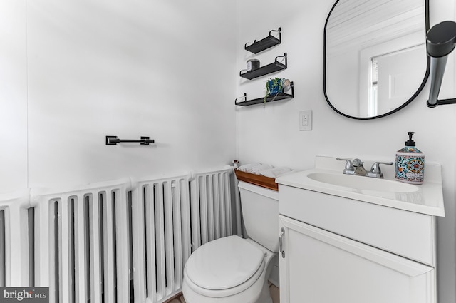 1112 Randall Ave, Upper Chichester, PA 19061 - half bathroom with radiator heating unit, vanity, and toilet