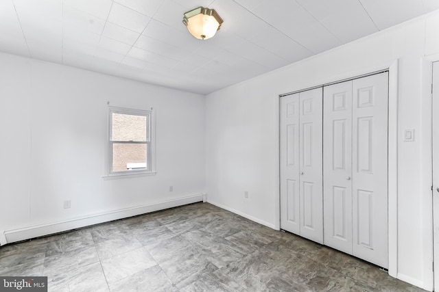 1112 Randall Ave, Upper Chichester, PA 19061 - unfurnished bedroom featuring baseboard heating, a closet, and baseboards