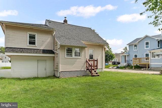 1112 Randall Ave, Upper Chichester, PA 19061 - back of property featuring a lawn, roof with shingles, and a chimney