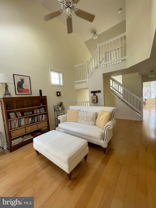 1369 Garden Wall Cir Unit 714, Reston, VA 20194 - living area featuring stairs, high vaulted ceiling, ceiling fan, and light wood-style flooring