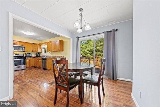 3 High Ridge Rd, Pemberton, NJ 08068 - dining area with light wood finished floors, baseboards, and a chandelier