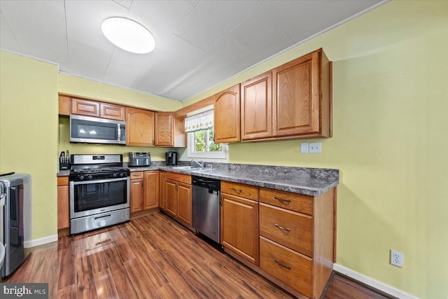 3 High Ridge Rd, Pemberton, NJ 08068 - kitchen featuring stainless steel appliances, dark wood-style flooring, a sink, and dark countertops