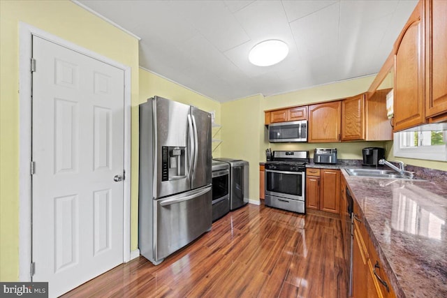 3 High Ridge Rd, Pemberton, NJ 08068 - kitchen with appliances with stainless steel finishes, washing machine and dryer, a sink, dark wood-type flooring, and brown cabinets