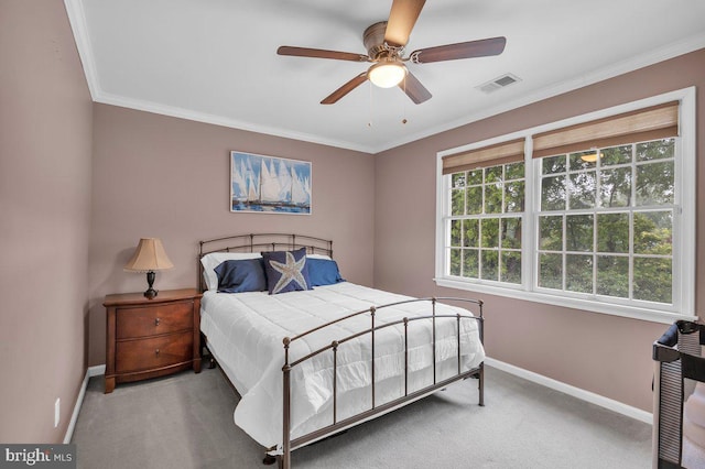 carpeted bedroom featuring baseboards, ornamental molding, and a ceiling fan