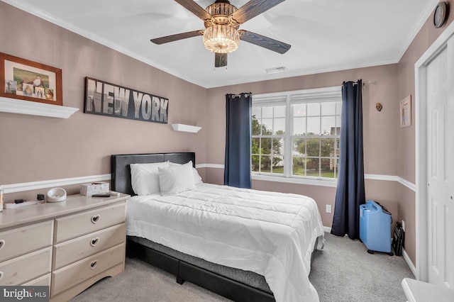 bedroom with carpet floors, baseboards, a ceiling fan, and crown molding