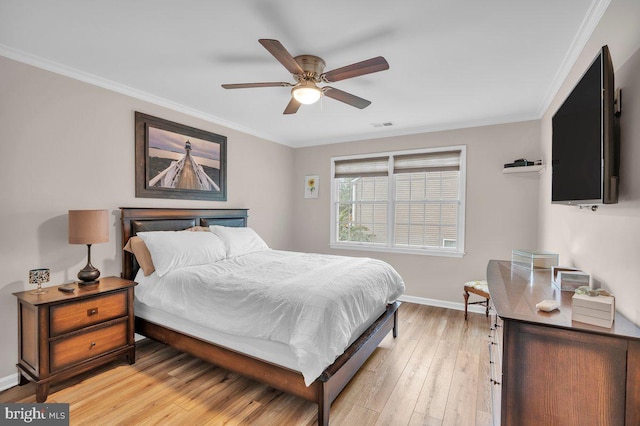 bedroom with baseboards, light wood finished floors, ornamental molding, and a ceiling fan