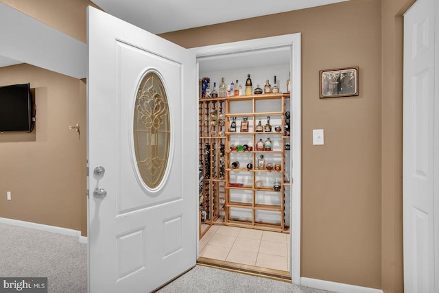 carpeted entrance foyer with baseboards